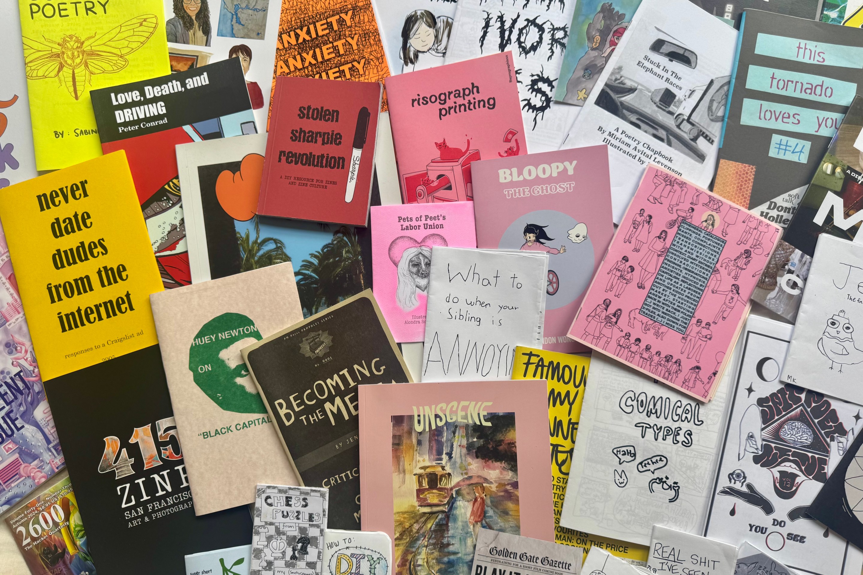 Several zines scattered on a flat surface.