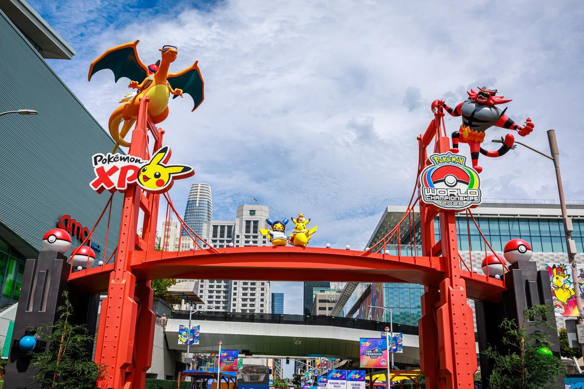 Pokémon XD theme park entrance with red gate, Charizard sculpture, and Pikachu signage